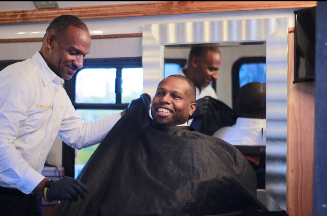 Christopher of Mobile Cuts sharing a laugh with a client inside the mobile studio